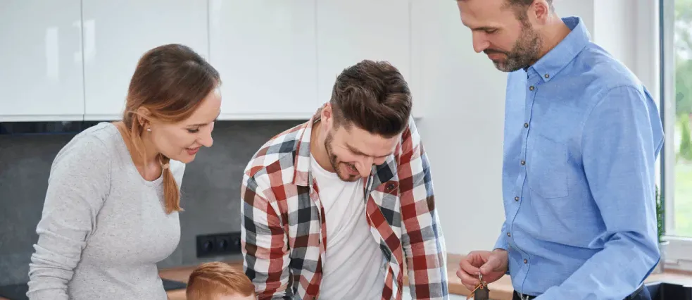 A young family filling in an application with a housing advisor