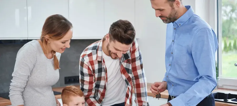 Young family signing papers with a housing advisor